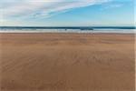 Sandy beach and North Sea at low tide in the morning at Bamburgh in Northumberland, England, United Kingdom