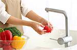 Japanese woman washing vegetables in the kitchen