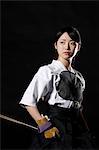 Japanese traditional archery athlete against black background