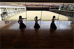 Multi-ethnic group of traditional archery athletes practicing