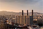 Elevated cityscape view with row of smokestacks, Barcelona, Spain