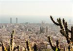 Elevated cityscape view with La Sagrada Familia and distant coast, Barcelona, Spain