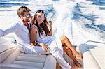 Portrait of couple relaxing on yacht, on water