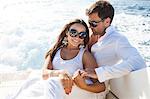 Couple relaxing on yacht, on water