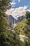 View of waterfall flowing from glazier at edge of  mountain rock face, Queulat National Park, Chile