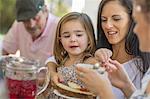 Girl having lunch with family outdoors