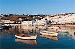 Boats by pier, town in background, Mykonos Town, Cyclades, Greece