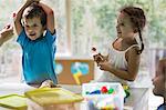 Teacher giving lollipop to children