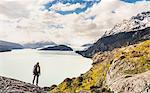 Male hiker looking out over Grey Lake and Glacier, Torres del Paine national park, Chile