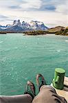 Male hiker's personal perspective over Grey Lake and Cuernos del Paine, Torres del Paine national park, Chile