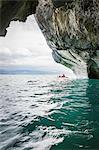 Woman kayaking around marble caves, Puerto Tranquilo, Aysen Region, Chile, South America