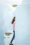 Girl walking behind wall, O'a, Santorini, Kikladhes, Greece