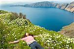 Girl asleep on bed of flowers, O'a, Santorini, Kikladhes, Greece