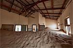 Interior of an abandoned building full of sand.