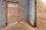 Interior of an abandoned building full of sand.