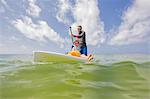 Father and daughter paddle boarding in the Gulf of Mexico, Destin, Florida, USA