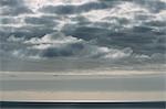 View from the land over the ocean, to the horizon. Open space, seascape and skyscape.