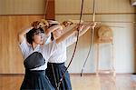 Multi-ethnic traditional Kyudo Japanese archery athletes practicing