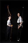 Multi-ethnic traditional Kyudo Japanese archery athletes on black background