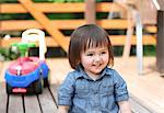 Mixed-race young girl playing on wooden deck