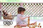 Mixed-race young girl with wooden blocks