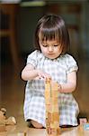 Mixed-race young girl with wooden blocks