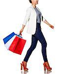 Shopping. The French way. Full length portrait of happy young woman with French flag colours shopping bags going to the side on white background