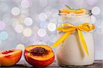 yogurt with peaches, bokeh background, closeup