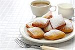 homemade new orleans beignet donuts and a cup of coffee