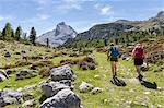 Italy,South Tyrol,Bolzano district,San Vigilio di Marebbe, Hikers in Fanes valley with Mount Piz Taibun in the background