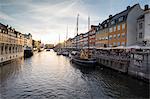 Colourful facades and typical boats along the canal and entertainment district of Nyhavn, Copenhagen, Denmark, Europe