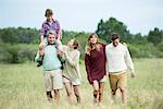 Family strolling together in field