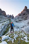 Tuckett refuge between the Brenta dolomites and alpinist at sunrise Europe, Italy, Trentino, Vallesinella, Tuckett refuge, Brenta dolomites