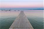 Wooden jetty on the Lake Garda (Lago di Garda) at dawn in Garda in Veneto, Italy