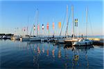 Row of boats and colorful European flags in the harbor marina on Lake Garda (Lago di Garda) at Bardolino in Veneto, Italy