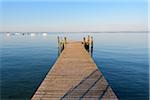 Wooden jetty on Lake Garda (Lago di Garda) on a sunny morning at Bardolino in Veneto, Italy