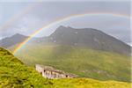 Rainbow over mountain landscape with mountain hut at Kaiser Franz Josefs Hohe in Grossglockner High Alpine Road in the Hohe Tauern National Park, Carinthia, Austria