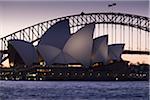 Sydney Opera House and the Sydney Harbour Bridge at dusk in Sydney, Australia