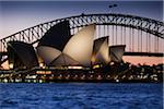 Sydney Opera House and the Sydney Harbour Bridge at dusk in Sydney, Australia