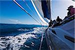 Group of people on a sailboat, sailing on the choppy waters around the Whitsunday Islands in Queensland, Australia