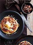 Pizza base with pecans and salted caramel, overhead view