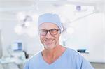 Portrait confident mature male surgeon in operating room