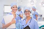 Portrait smiling, confident female surgeons in operating room