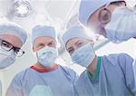 Portrait confident surgeons wearing surgical masks in operating room