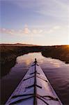 Personal perspective of kayak on river at sunset, Morro Bay, California, USA