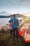 Couple standing beside tent, looking at view, Heeney, Colorado, United States