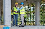 Construction workers in discussion on building site