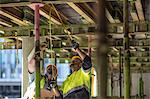 Construction workers measuring building