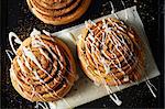 Cinnamon Rolls drizzled with Icing on wax paper