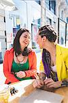 Women on city break at outdoor cafe, Milan, Italy